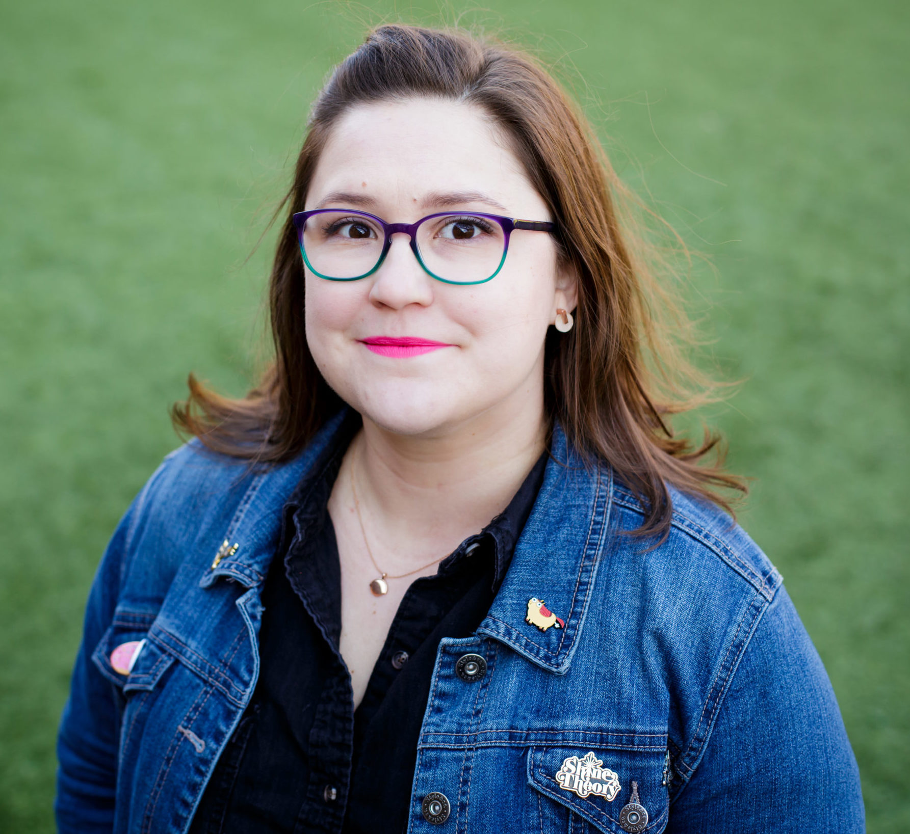 headshot of a lady with glasses and bright lipstick